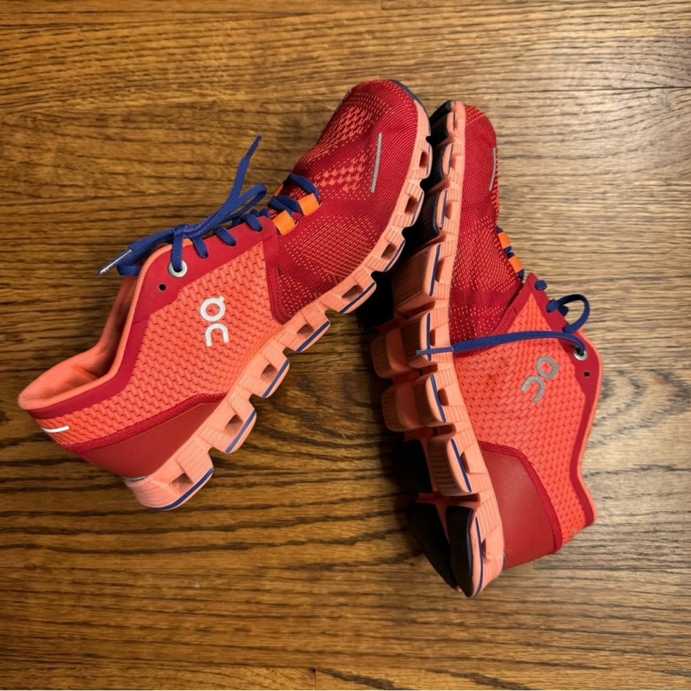 On Running Red Sneakers with Blue Accents